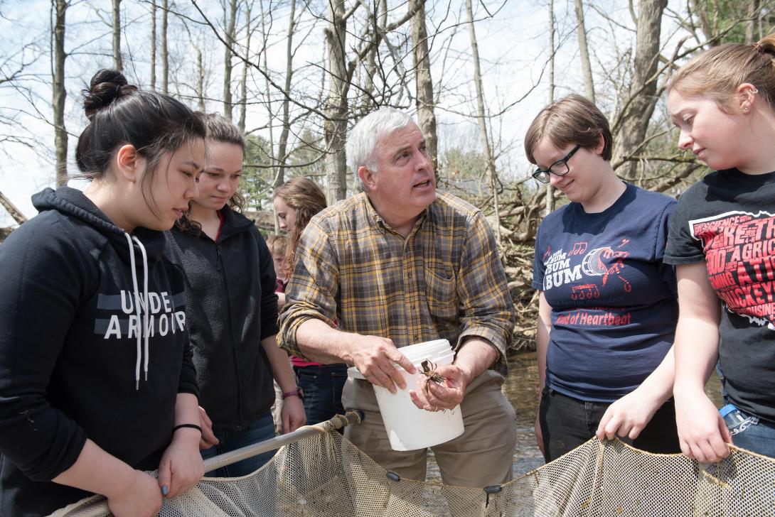 Students with Professor Stoffer, examining animals found in stream at Canfield Preserve