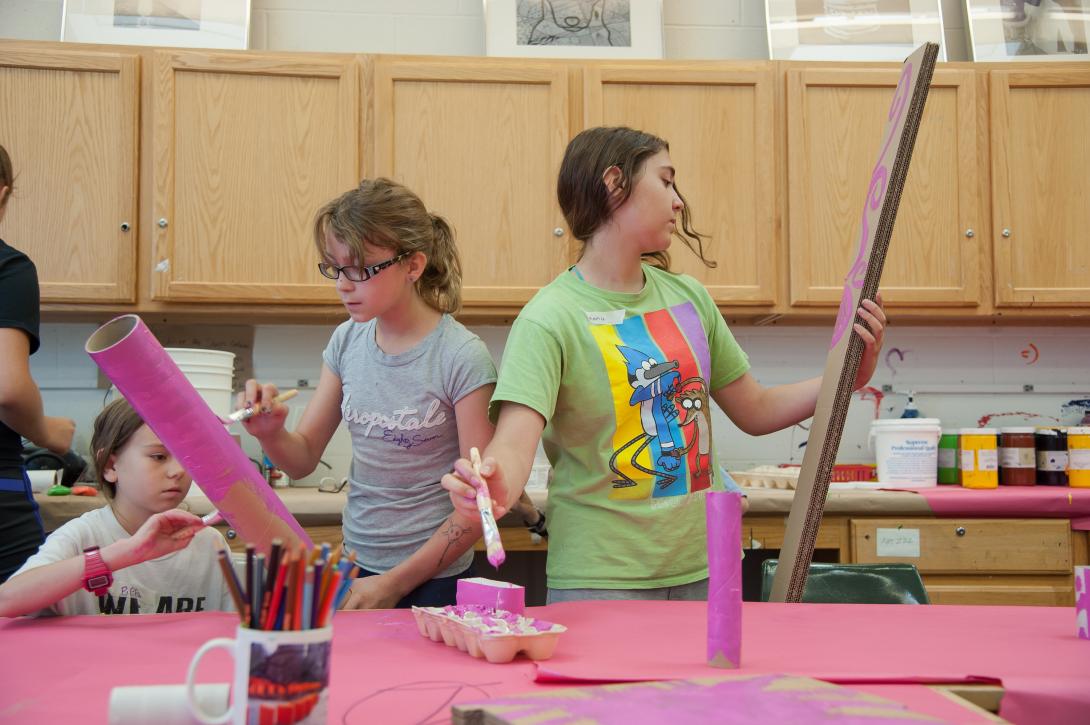 Youth working with supplies at art camp