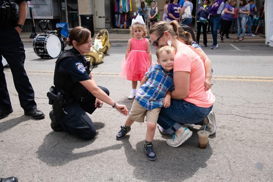 Police officer talking to a child at Ashland Palooza community parade