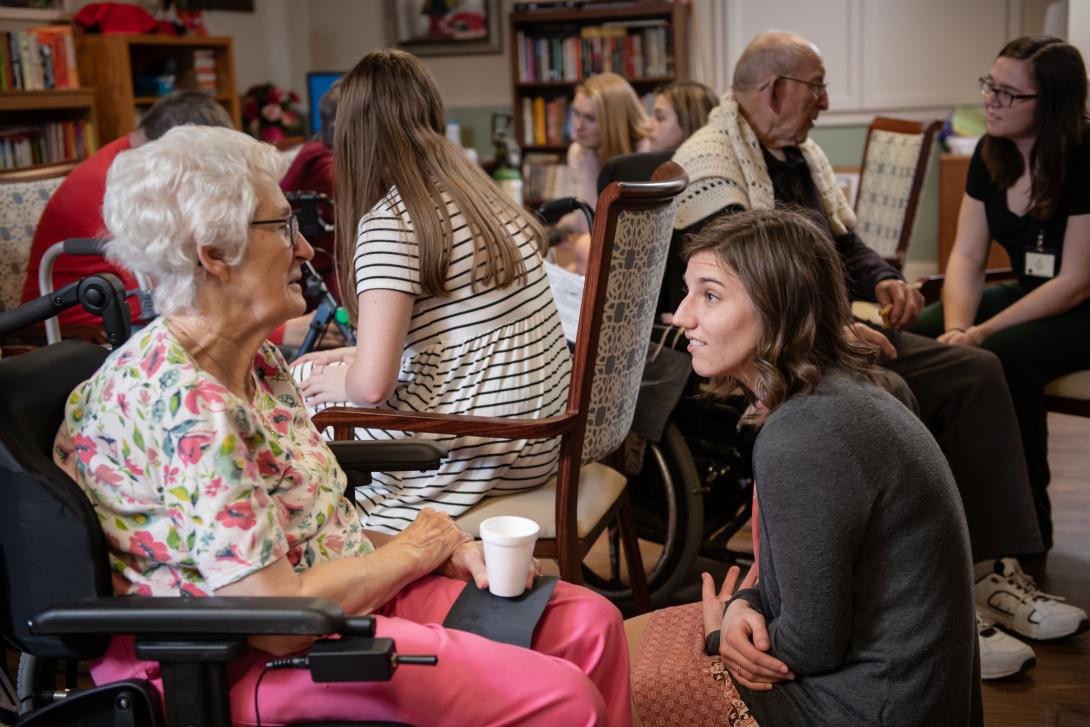 Student with AU GIVS visits with a resident of Good Shepherd nursing home