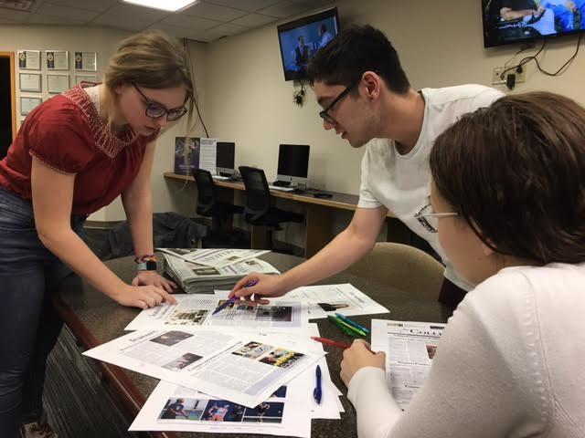 Collegian editors looking over proofs for the next issue