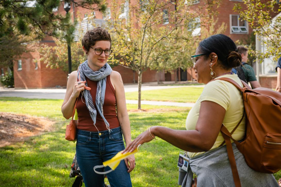 MFA Summer Residency participants talking to each other on campus