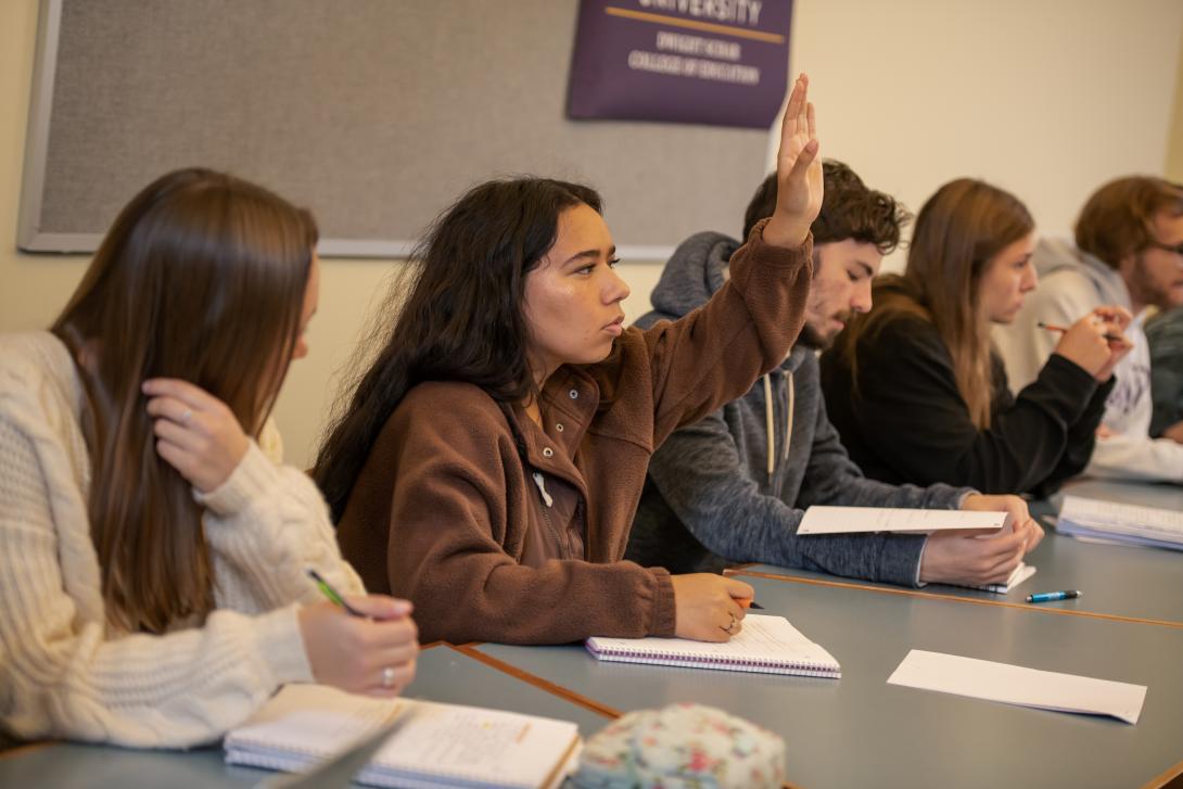 Student in Psychology class raising her hand