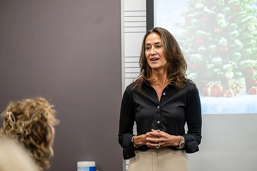 Annette Hruby of The Hruby Group at the piano lab dedication event