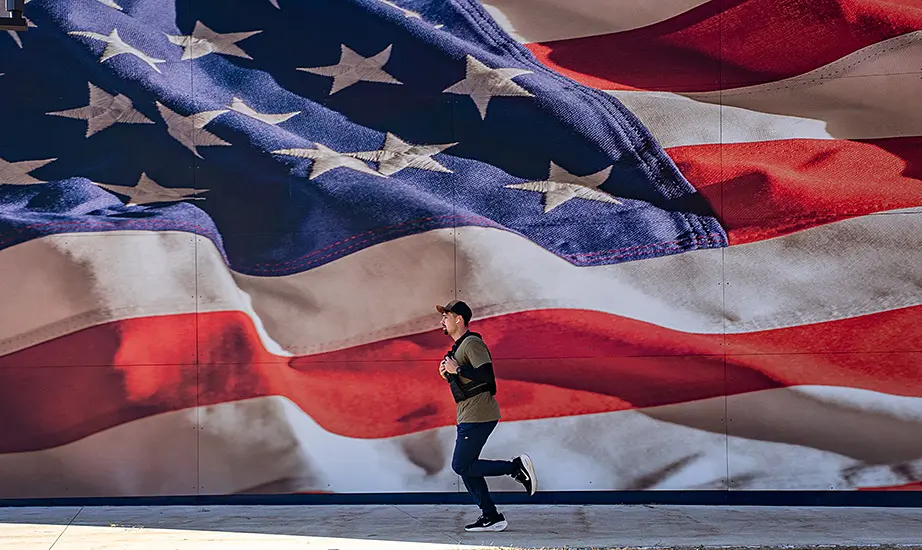 Kayin McDonald running in front of a huge American flag