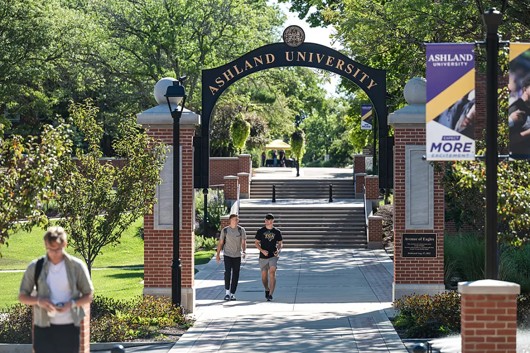students walking through an arch during the first day of classes in fall 2025