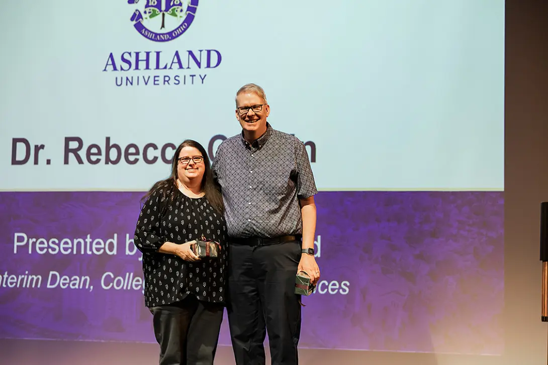 Rebecca and Perry Corbin accept their dual 25-year service awards at the 2026 All-Institutional Meeting