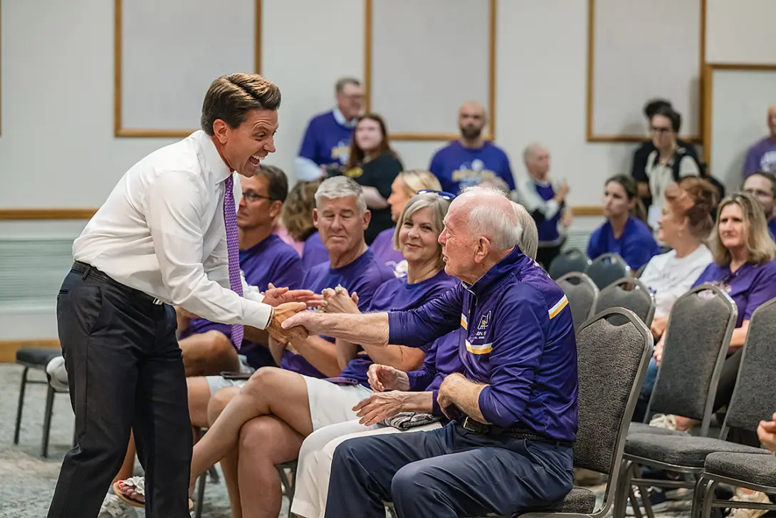 Matt Miller '99, mayor of the City of Ashland, congratulates Bob Archer